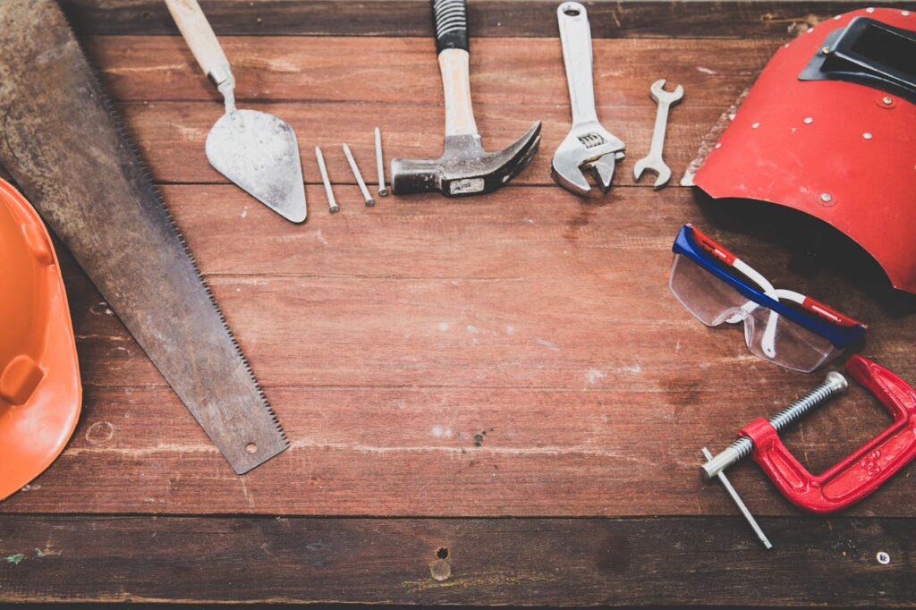 pexels photo 1029243 Flat lay of various workshop tools on a rustic wooden table, showcasing DIY essentials.